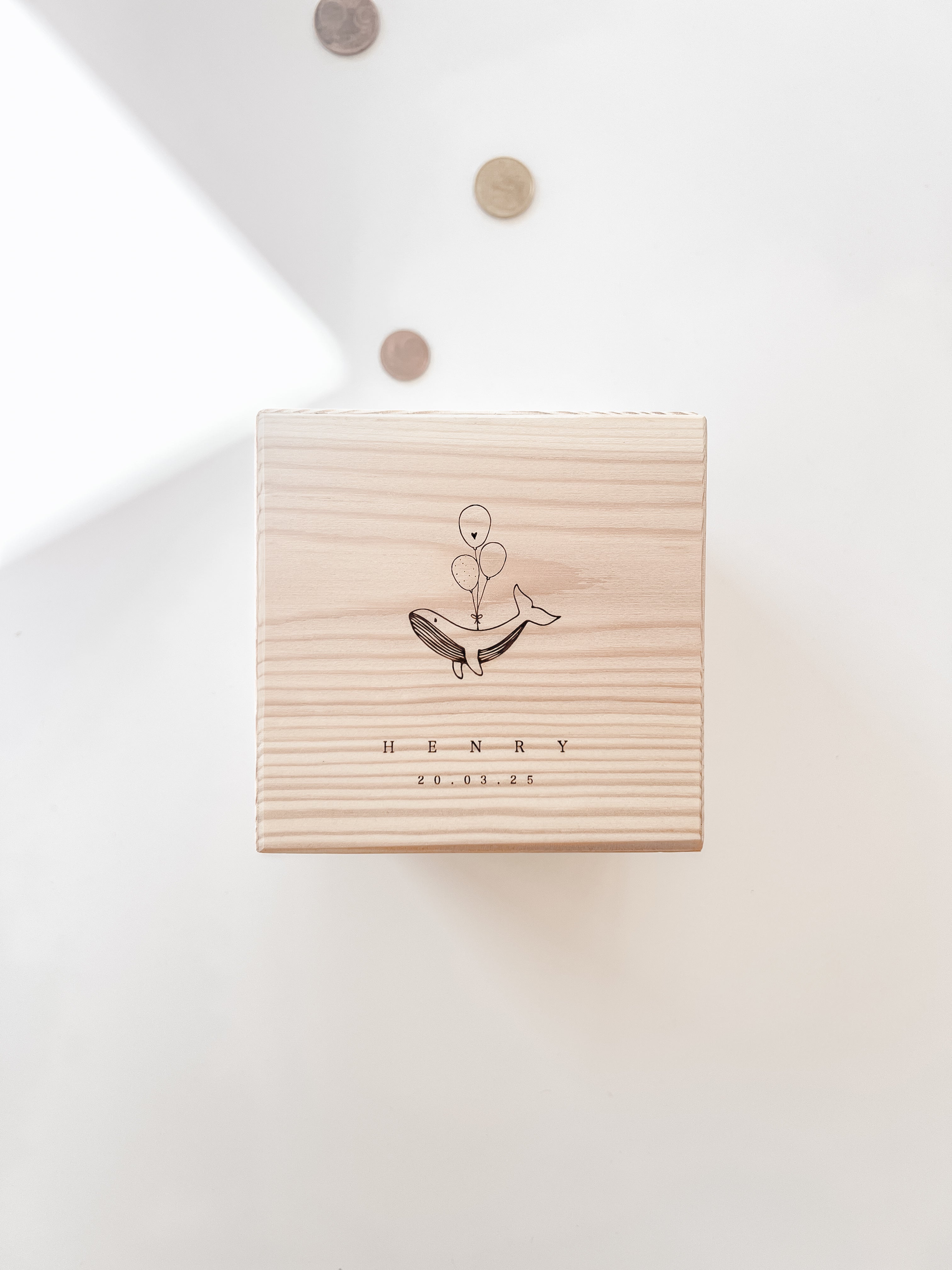 Nahaufnahme der Holzgravur mit kleinem Wal auf personalisierter Spardose.